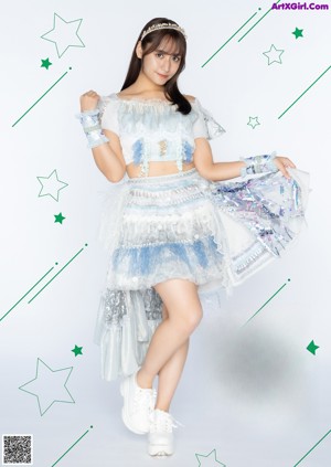 A young woman in a blue and white outfit posing for a picture.