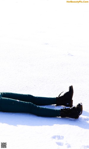 A woman laying on top of a wooden table.