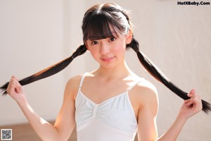 A young woman sitting on a set of stairs.