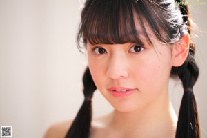 A young ballerina sitting on a set of stairs.