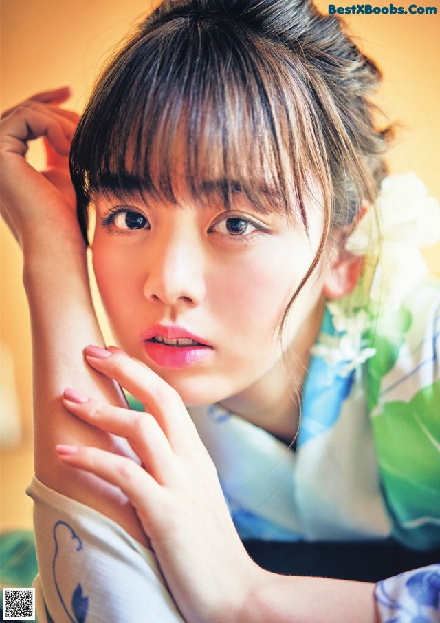 A woman in a kimono is posing for a picture.
