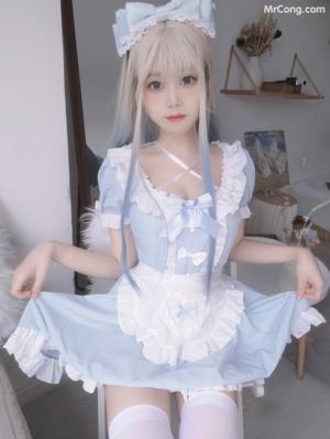 A woman in a white lingerie posing for a picture.
