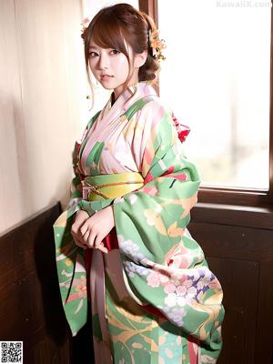 A woman in a bikini posing in a kimono.