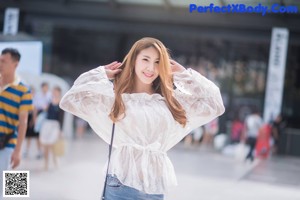 A woman in a colorful dress posing for a picture.