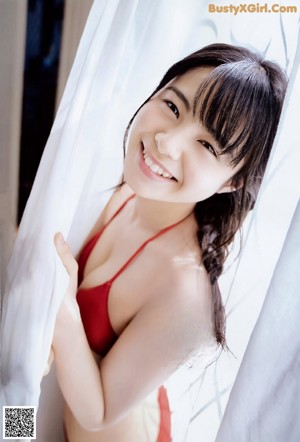 A young woman laying on top of a wooden table.