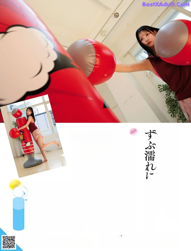 A woman in a red shirt is punching a punching bag.