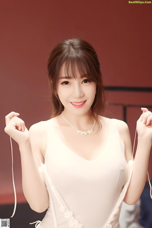 A woman in a white bra and panties posing for a picture.